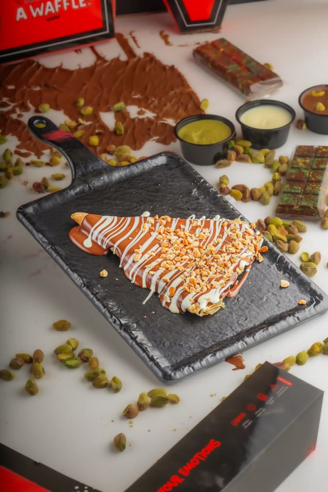 A Papa Chocolate crepe folded and dipped in chocolate
