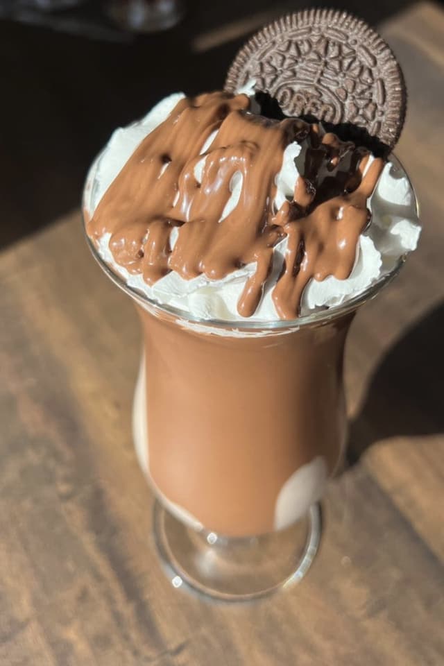 A Papa Chocolate milkshake topped with dessert